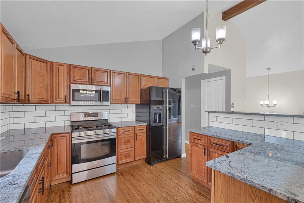 122 Fulton Road Canonsburg, PA 15317 - Photo 10 of 25 a kitchen with stainless steel appliances granite countertop a stove top oven a sink dishwasher and a refrigerator