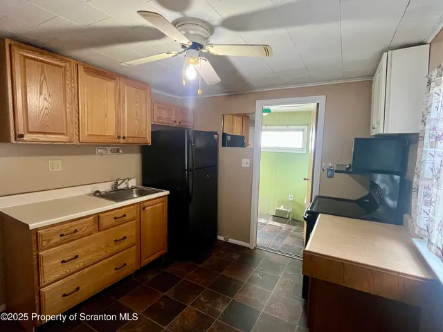 a kitchen with stainless steel appliances a stove a refrigerator and a cabinets