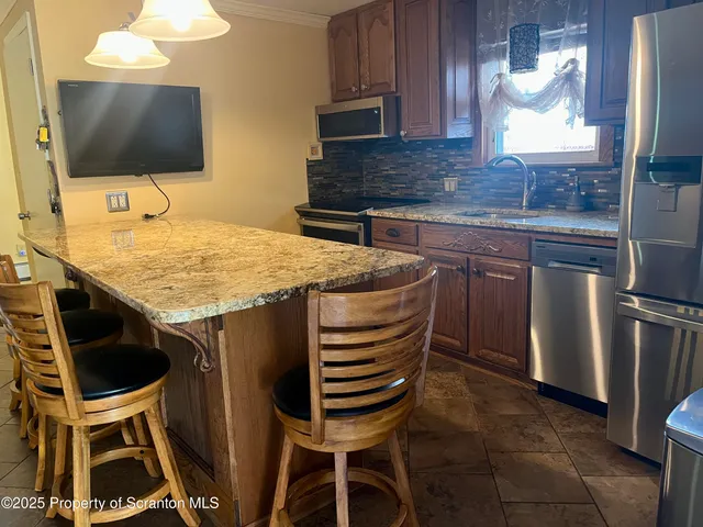 a kitchen with a sink cabinets and wooden floor