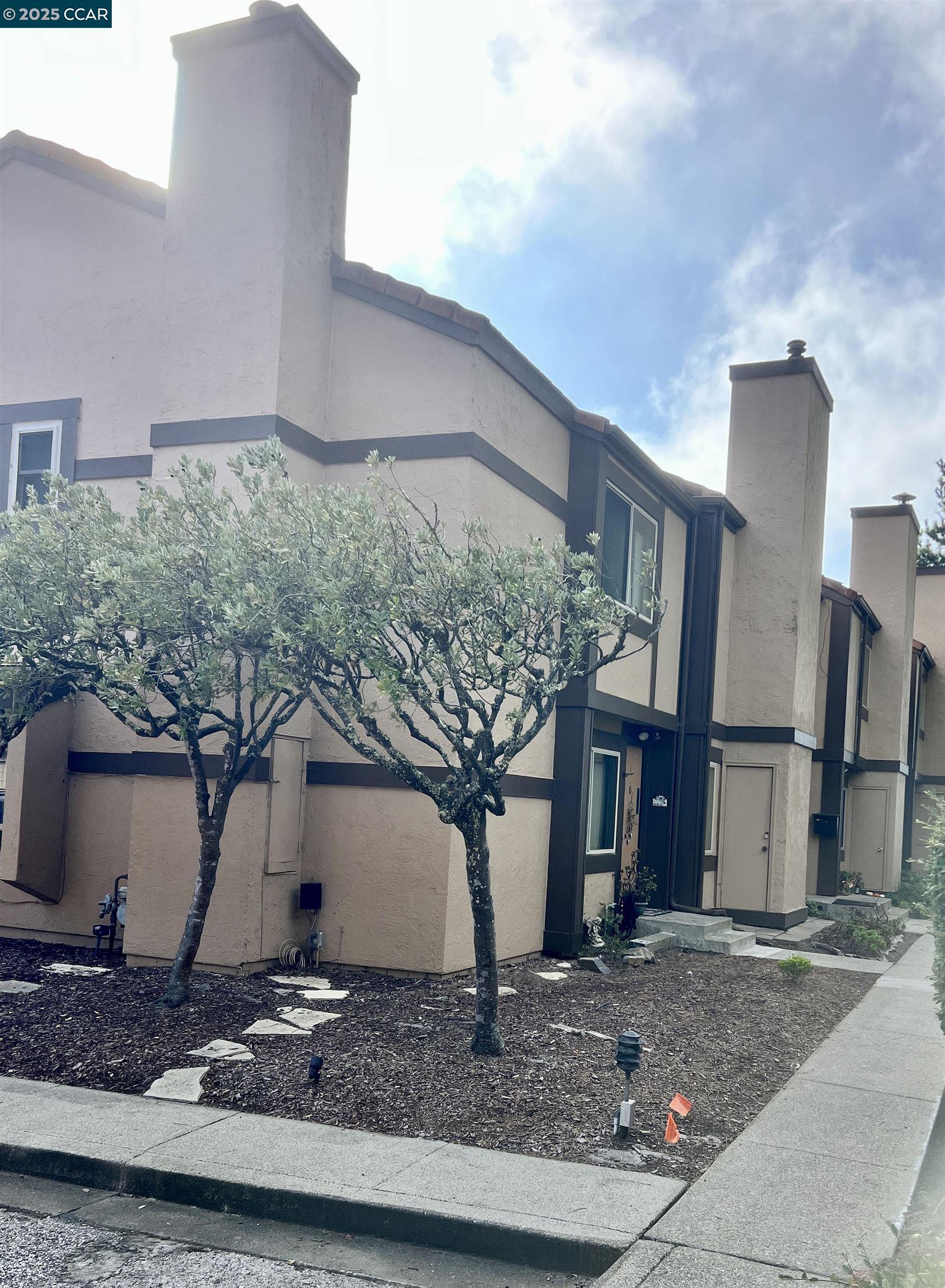 a front view of a house with garden