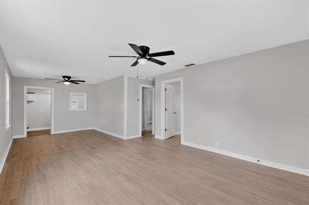 313 Farm To Market 316 Eustace, TX 75124 - Photo 8 of 33 a view of a livingroom with a ceiling fan & wooden floor
