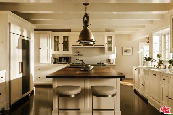 a kitchen with stainless steel appliances granite countertop a sink and wooden cabinets