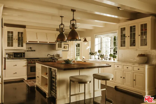 a kitchen with stainless steel appliances granite countertop a stove and cabinets