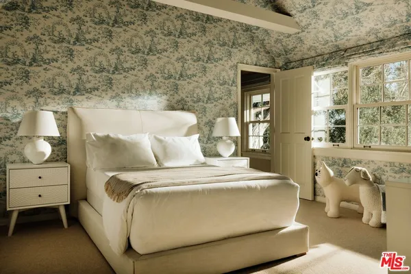 a bedroom with bed and windows