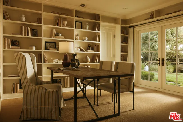 a dining room with furniture and a floor to ceiling window