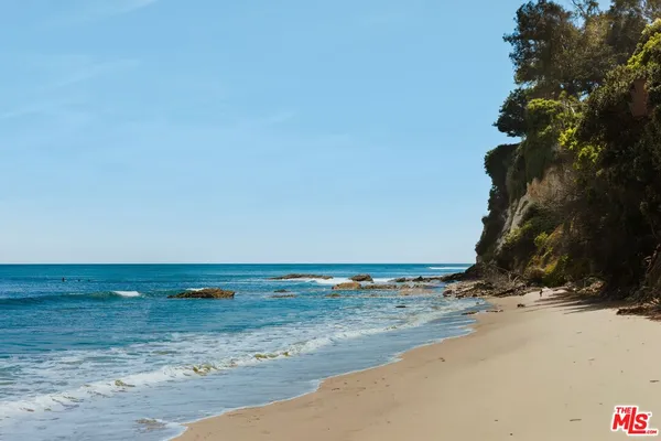 a view of an ocean with a mountain