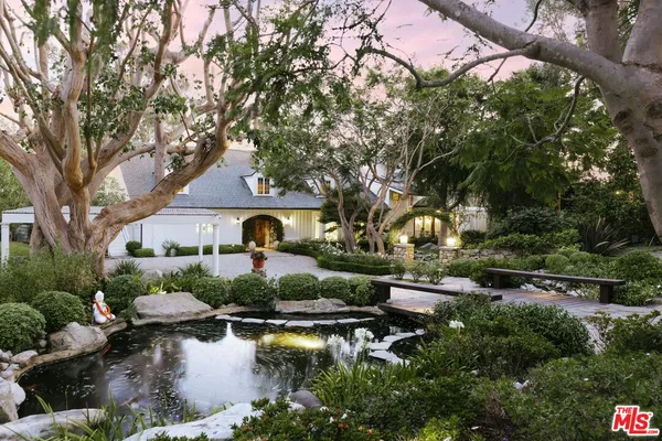 a view of a house with a yard and garden