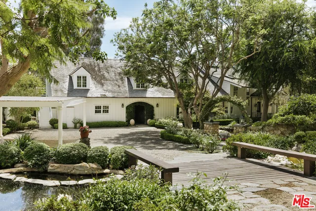 an aerial view of a house with a yard and lake view