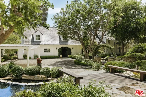 an aerial view of a house with a yard and lake view