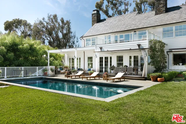 a view of a house with swimming pool and a yard