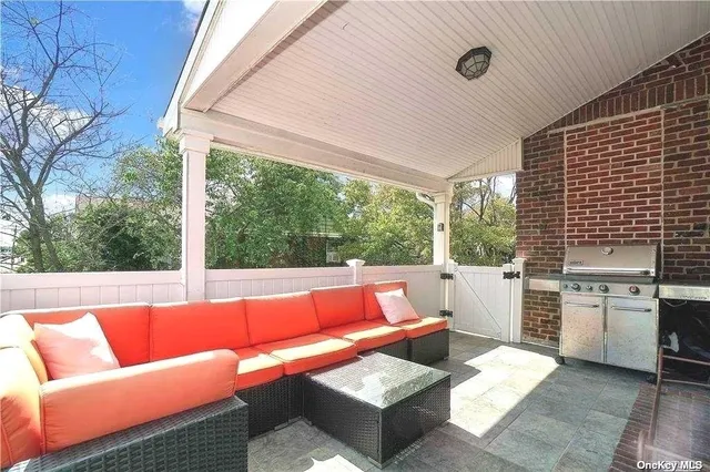 a outdoor living space with furniture and a grill