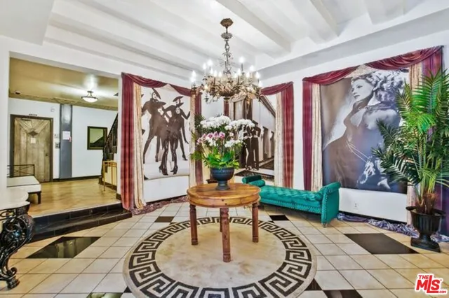 a living room with furniture and a chandelier