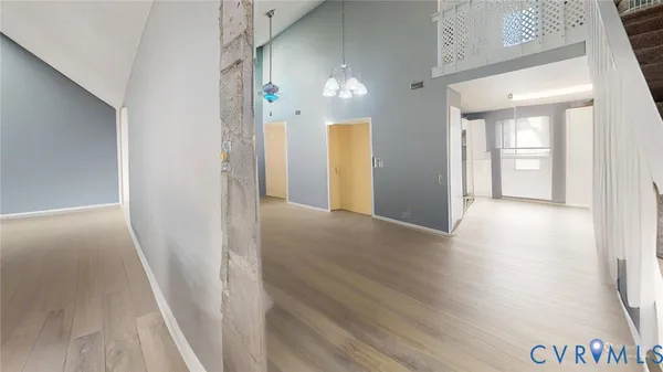 a bedroom with a bed and a flat tv screen on dresser