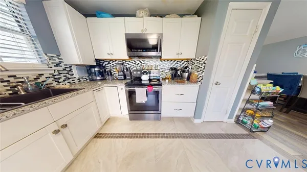a kitchen with a sink and a stove top oven