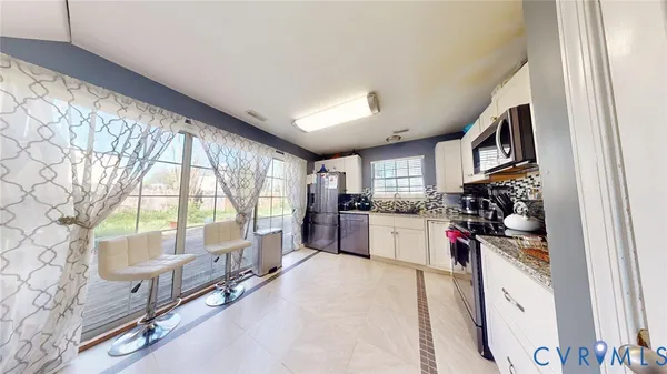 a kitchen with stainless steel appliances a stove refrigerator and a cabinets