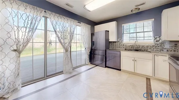 a kitchen with stainless steel appliances granite countertop a refrigerator and a sink