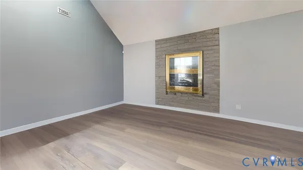 a living room with furniture a flat screen tv and a couch