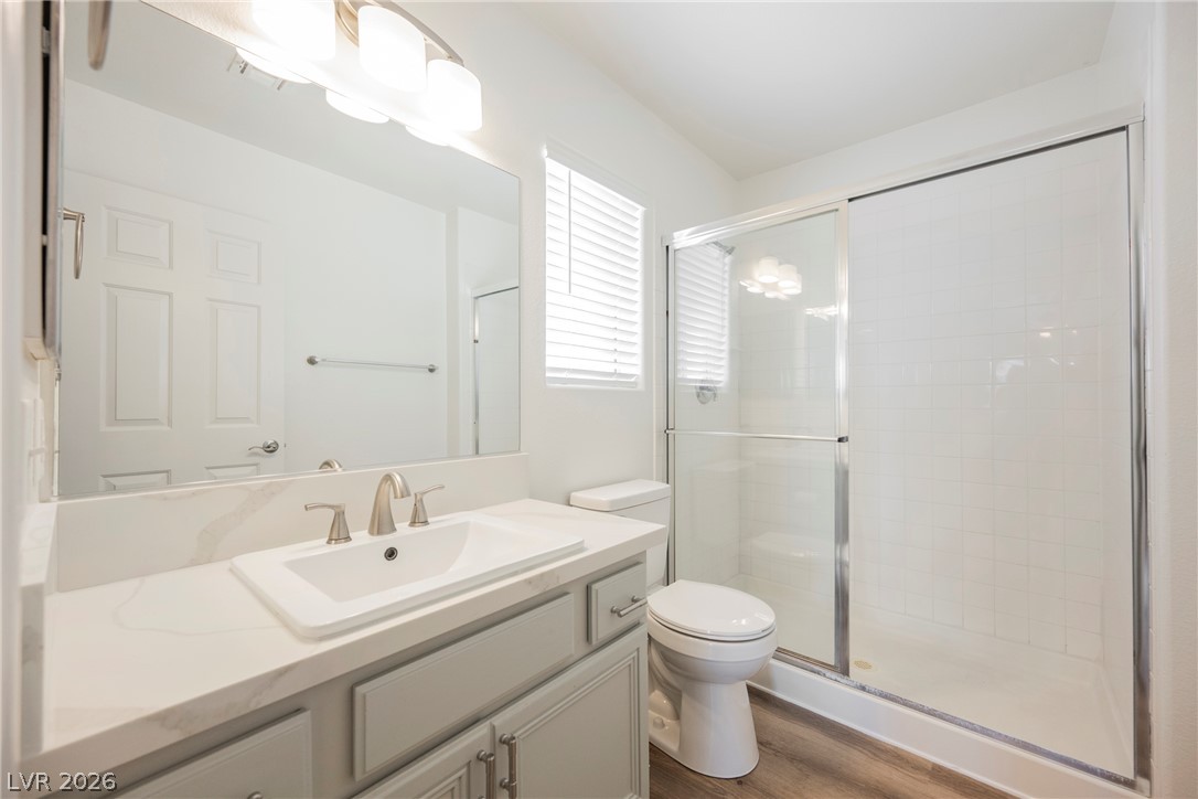 112 Iridescent Street Henderson, NV 89012 - Photo 13 of 24 A well-appointed bathroom with a spacious vanity, sleek fixtures, and a bright, tiled shower enclosure.