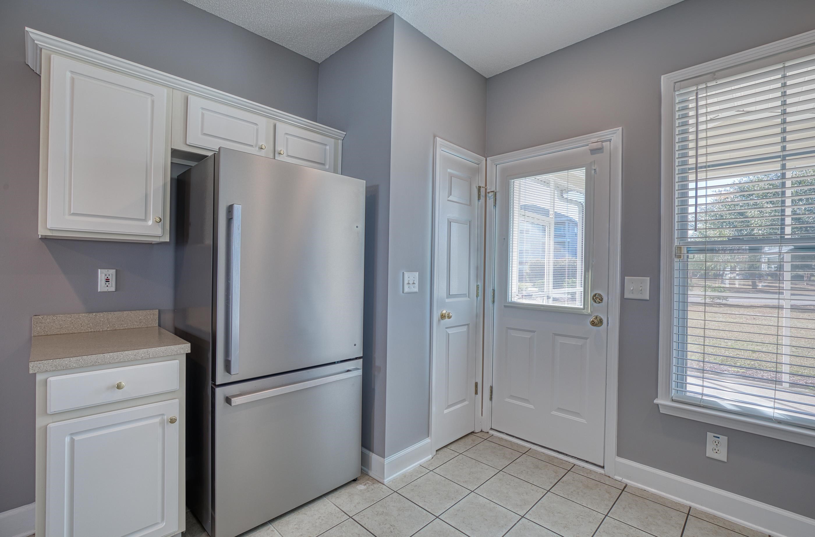 205 Threshing Way, Unit 1050 Myrtle Beach, SC 29579 - Photo 11 of 40 Kitchen with freestanding refrigerator, light countertops, white cabinets, and light tile patterned flooring