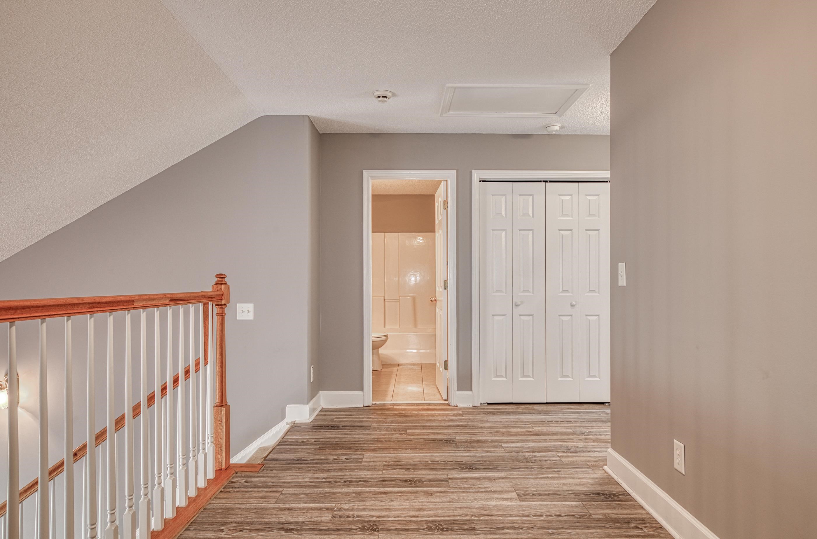 205 Threshing Way, Unit 1050 Myrtle Beach, SC 29579 - Photo 26 of 40 Hallway featuring a textured ceiling, light wood-type flooring, attic access, and lofted ceiling