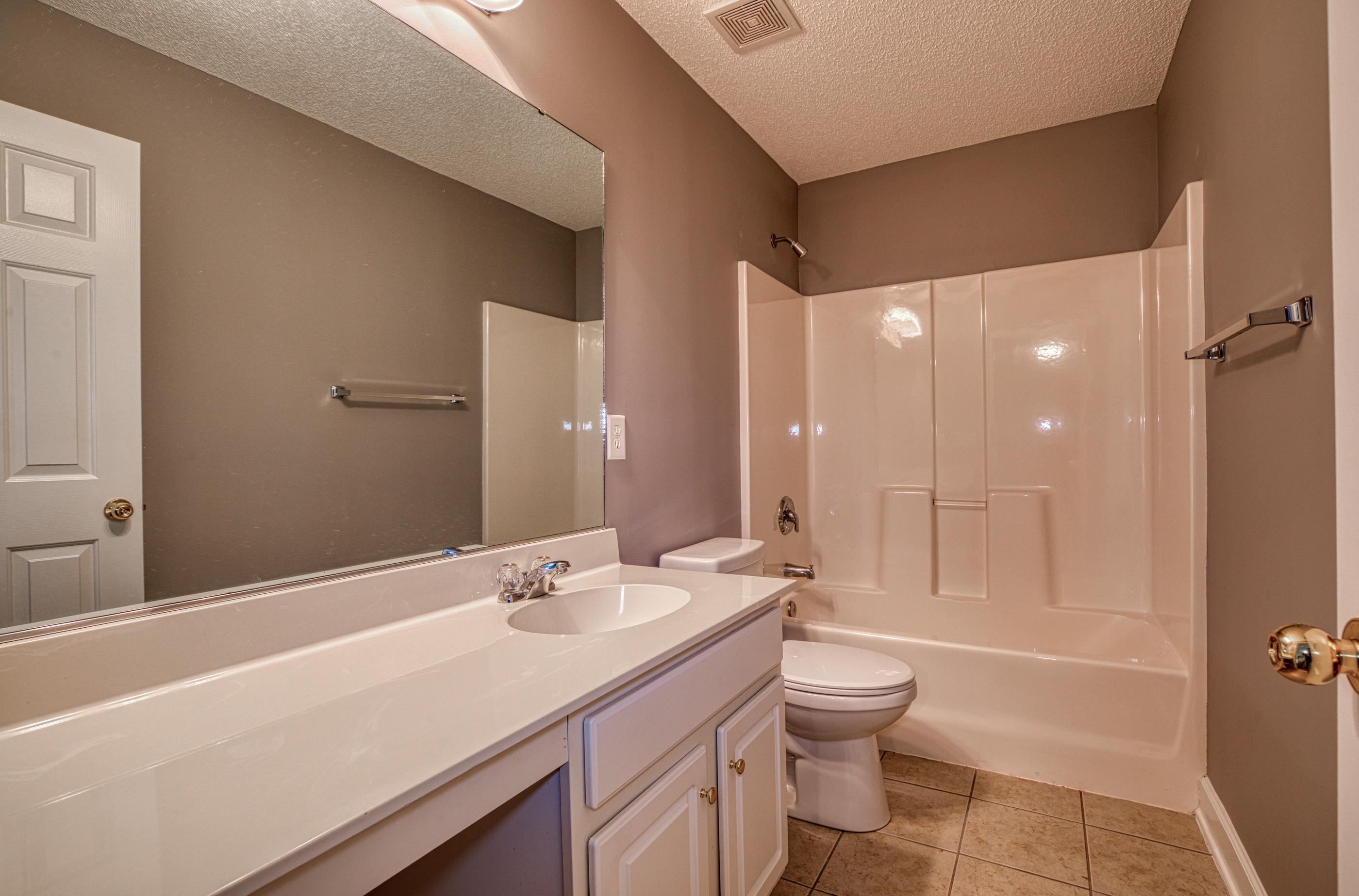 205 Threshing Way, Unit 1050 Myrtle Beach, SC 29579 - Photo 27 of 40 Bathroom featuring a textured ceiling, vanity, shower / bath combination, and light tile patterned flooring