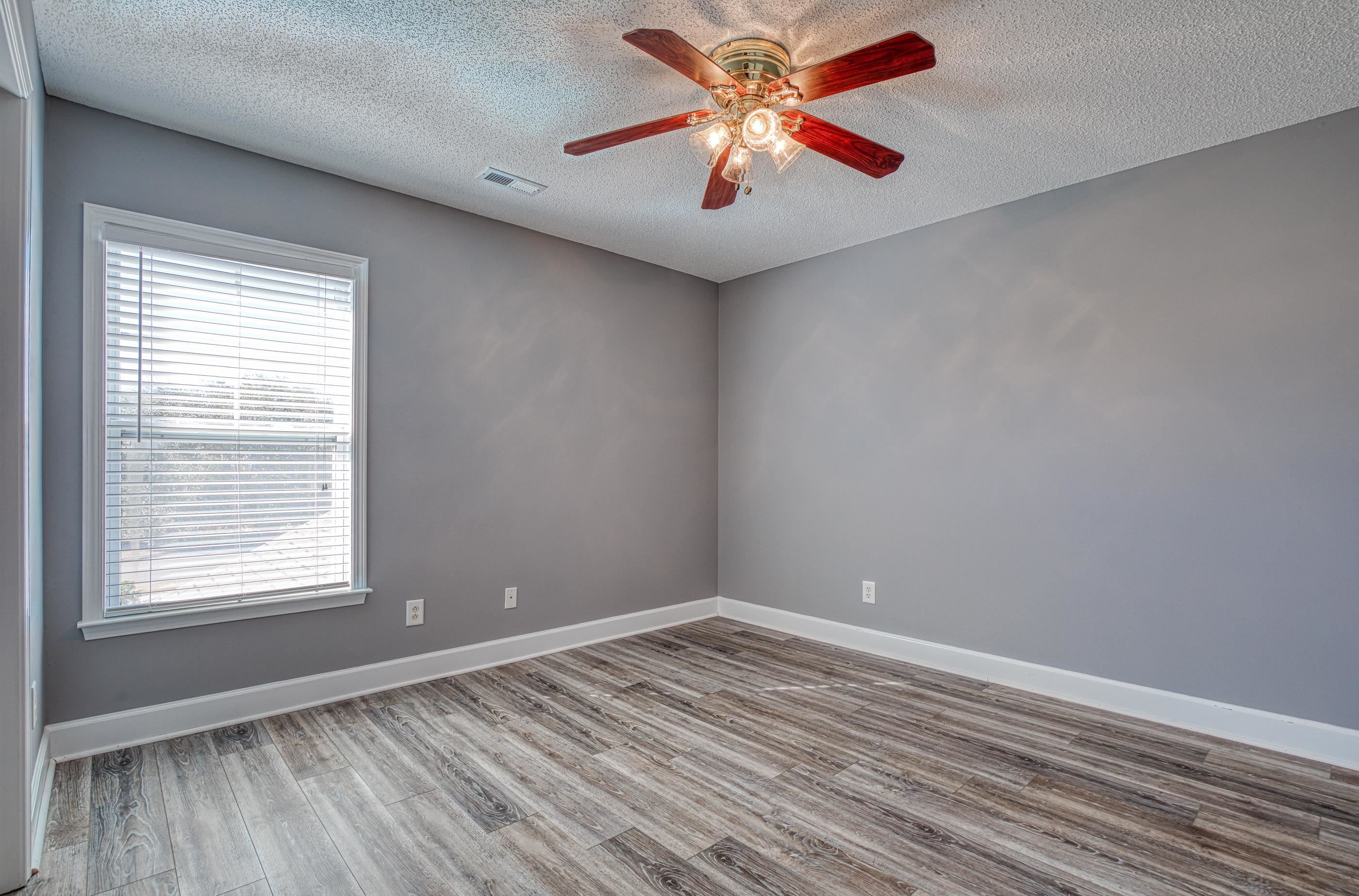 205 Threshing Way, Unit 1050 Myrtle Beach, SC 29579 - Photo 28 of 40 Empty room featuring a textured ceiling, wood finished floors, and a ceiling fan