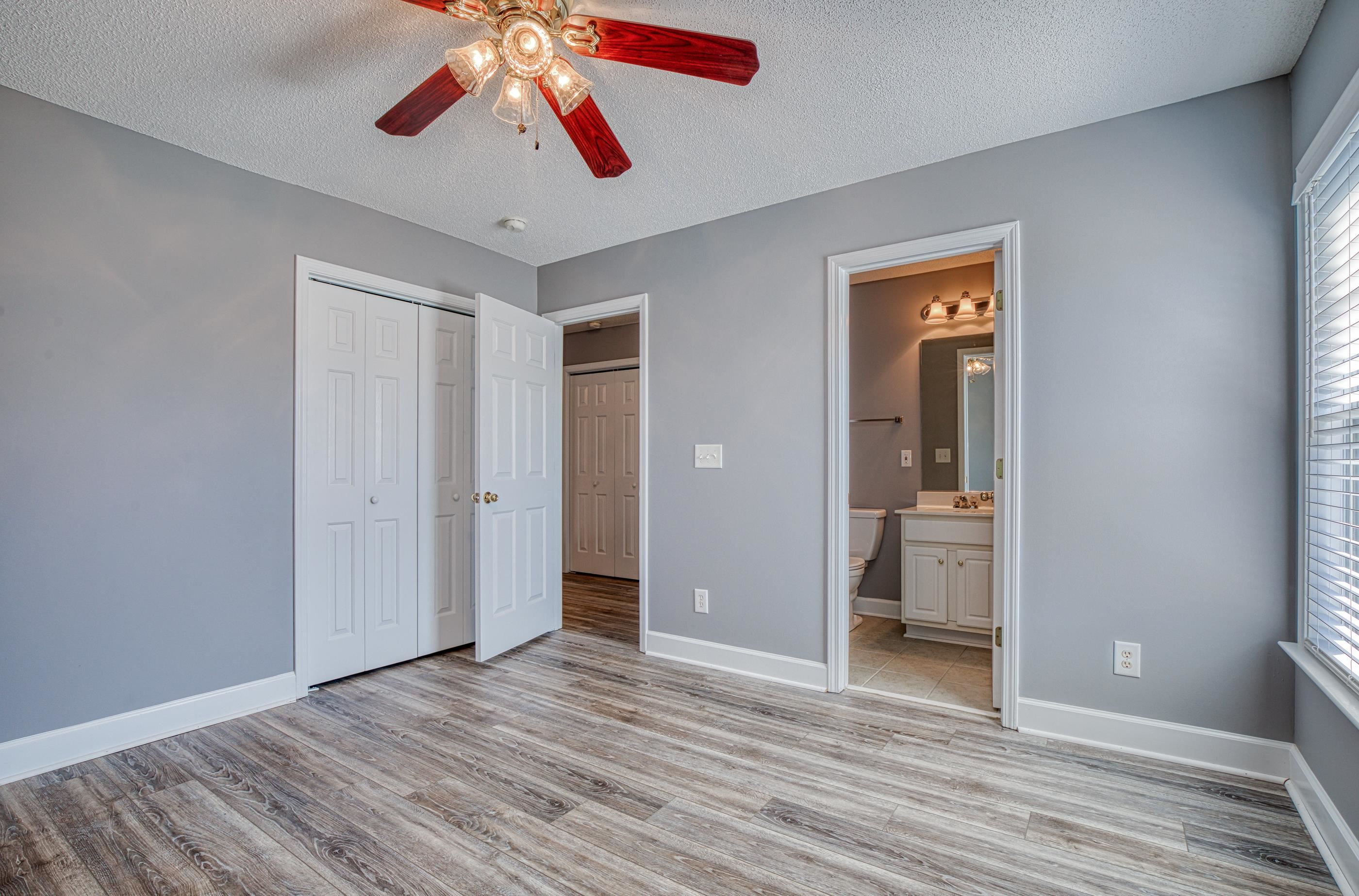 205 Threshing Way, Unit 1050 Myrtle Beach, SC 29579 - Photo 29 of 40 Unfurnished bedroom featuring a textured ceiling, light wood finished floors, a ceiling fan, ensuite bathroom, and a closet