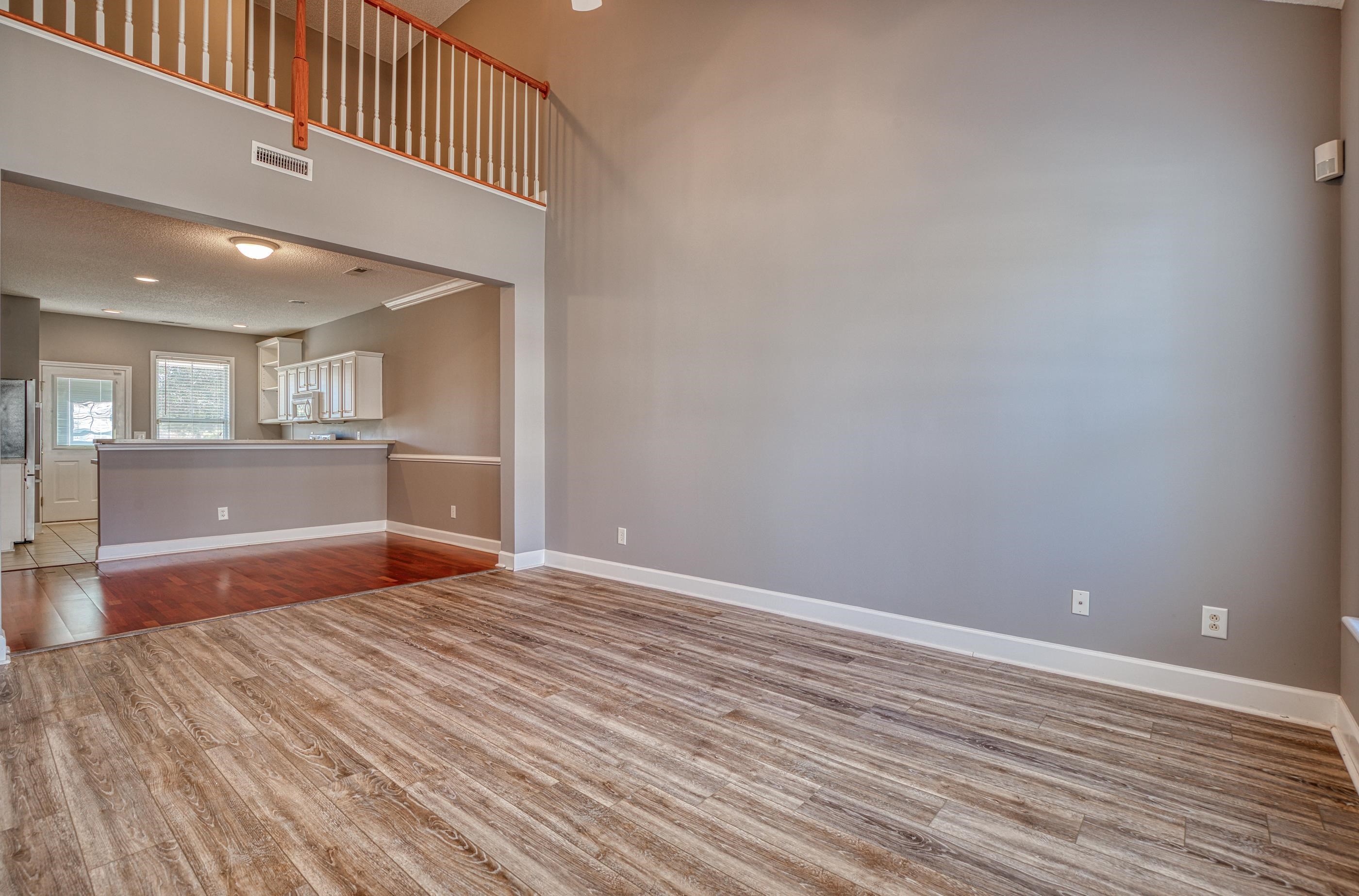 205 Threshing Way, Unit 1050 Myrtle Beach, SC 29579 - Photo 4 of 40 Unfurnished living room with light wood-type flooring, recessed lighting, a towering ceiling, and a textured ceiling