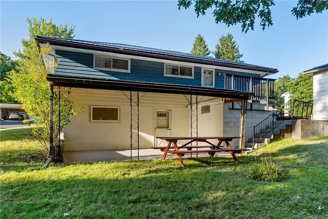 a backyard of a house with table and chairs
