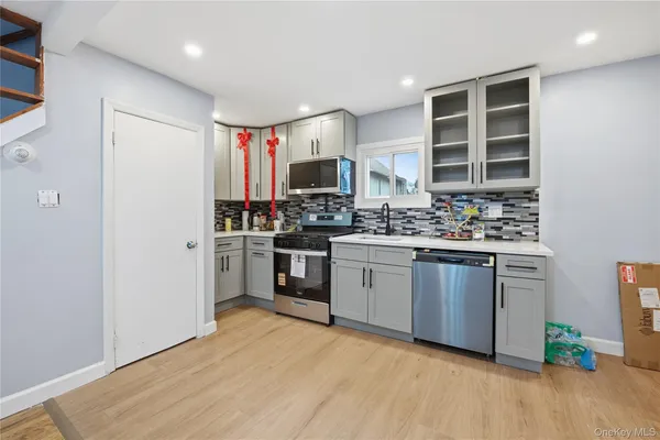 a kitchen with stainless steel appliances kitchen island granite countertop a stove and a sink