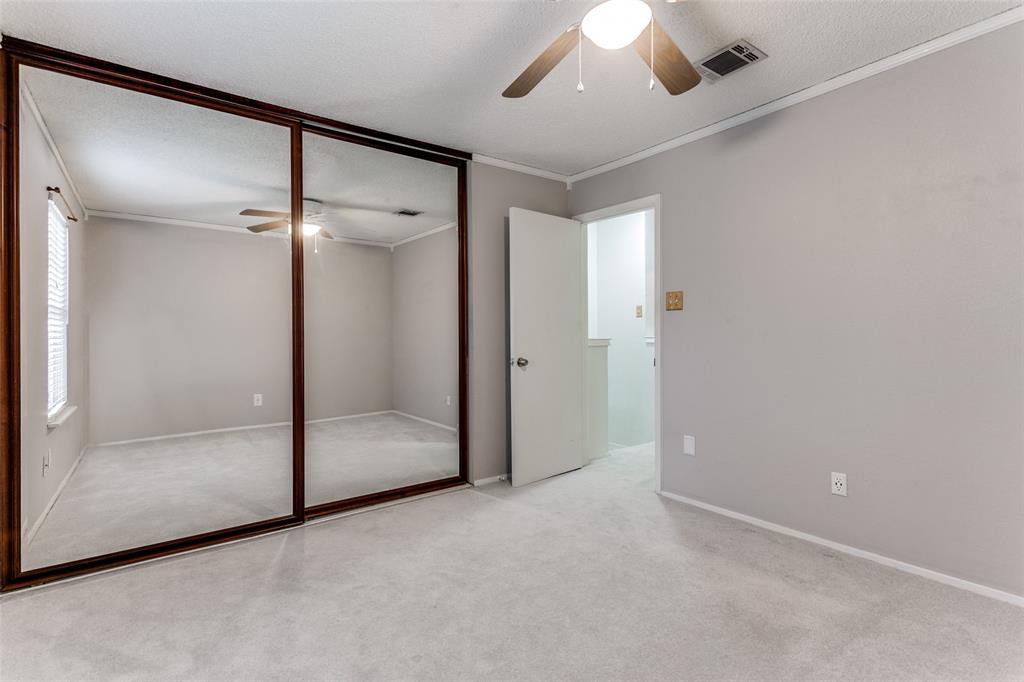 17 Abbey Road Euless, TX 76039 - Photo 17 of 23 Secondary bedroom with ceiling fan, large closet and carpet.