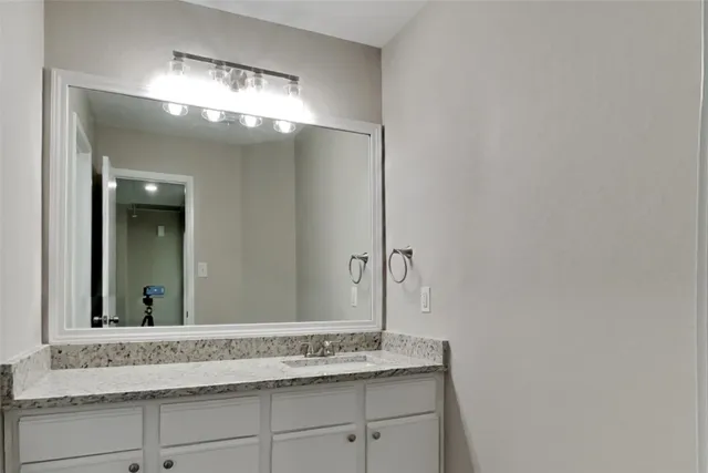 a view of a mirror and cabinets