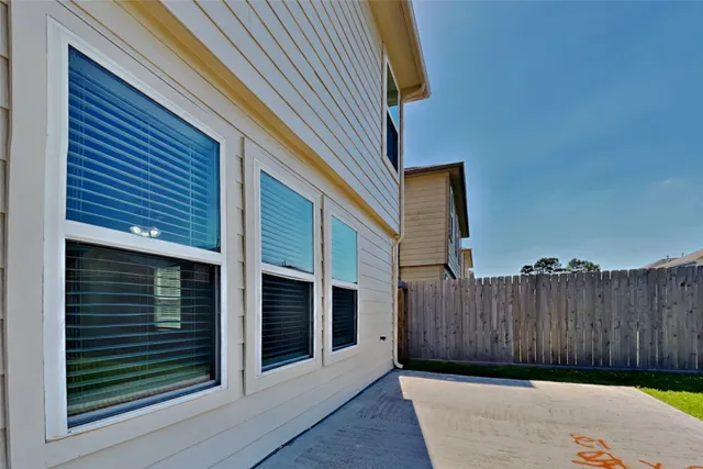 a view of a house with a wooden fence