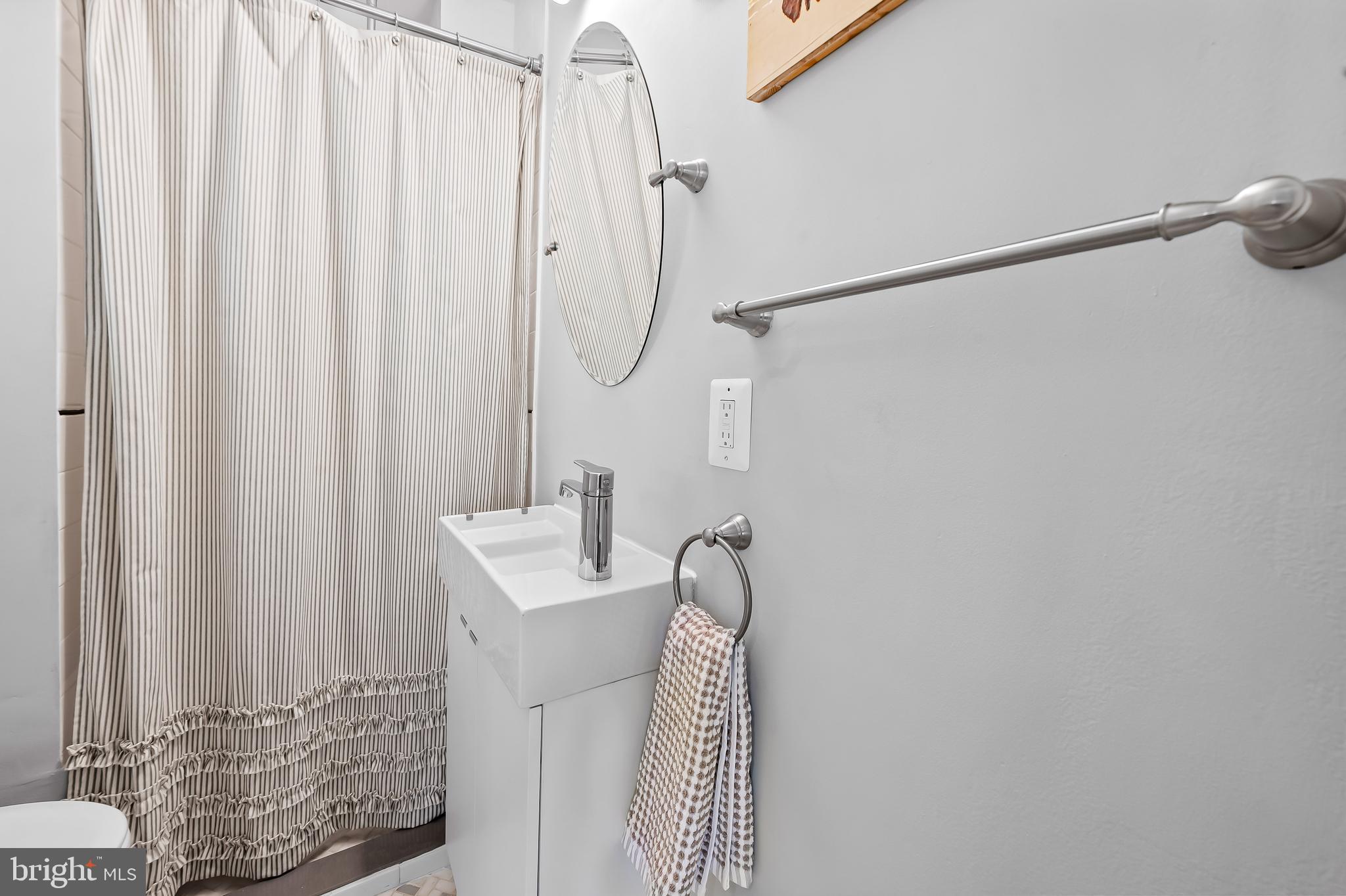 4605 Schenley Road Baltimore, MD 21210 - Photo 16 of 44 a bathroom with a shower curtain and a shower curtain