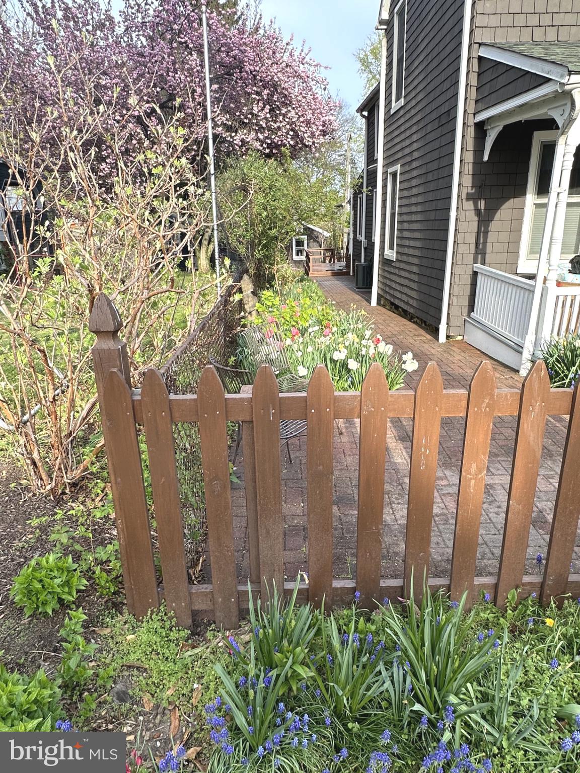 4605 Schenley Road Baltimore, MD 21210 - Photo 32 of 44 a view of a brick house with plants and wooden fence