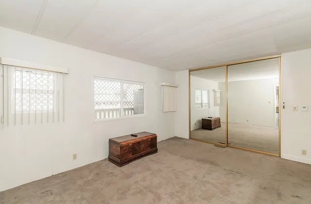 a spacious bedroom with a bed and a window