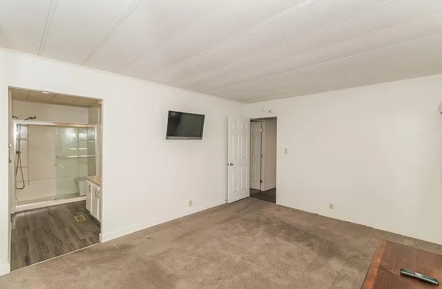 a spacious bathroom with a granite countertop sink mirror and