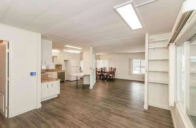 a kitchen with wooden floor and white appliances