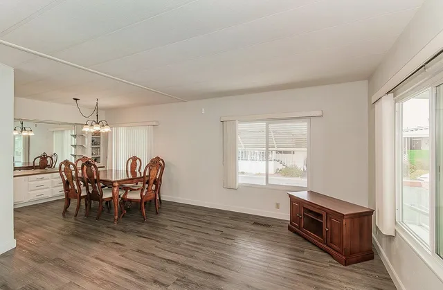 a view of a dining room with furniture window and wooden floor