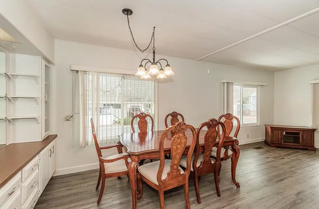 a view of a dining room with furniture window and wooden floor