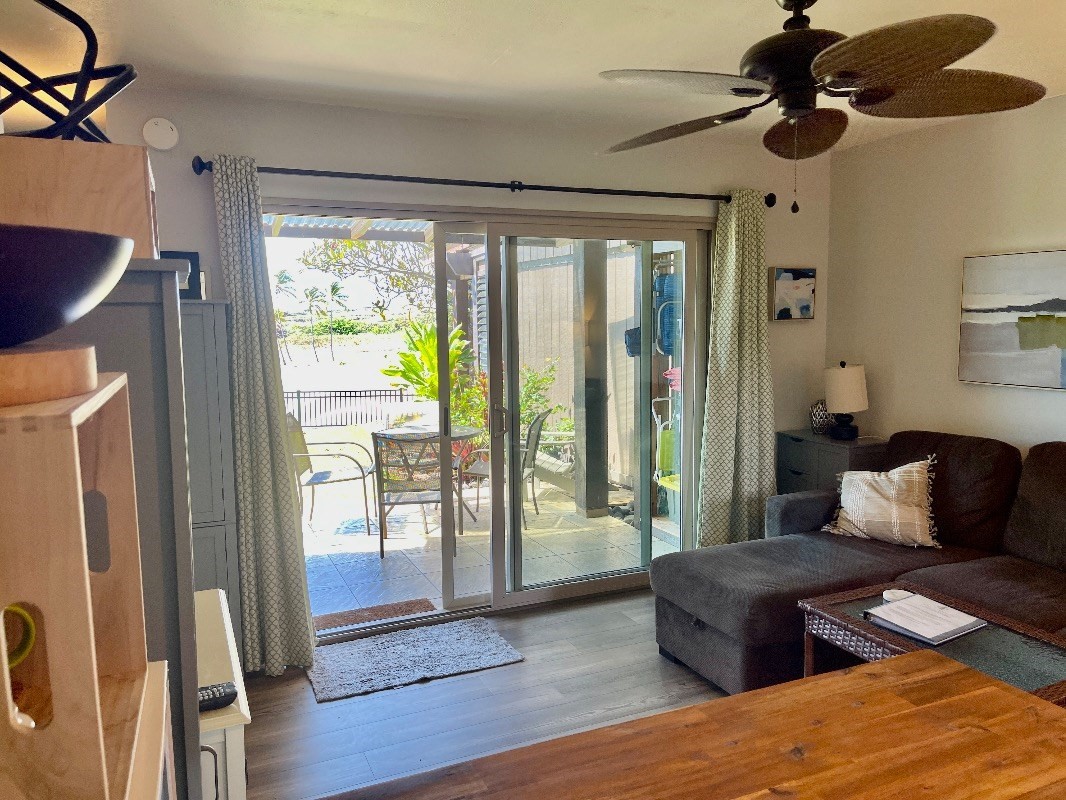 95-788 Ninole Loop Road, Unit 41 Naalehu, HI 96772 - Photo 14 of 19 a bedroom with a bed and wooden floor