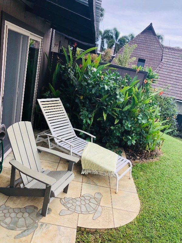 95-788 Ninole Loop Road, Unit 41 Naalehu, HI 96772 - Photo 18 of 19 a view of a patio with chair and tables back yard of the house