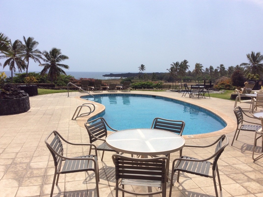 95-788 Ninole Loop Road, Unit 41 Naalehu, HI 96772 - Photo 19 of 19 a view of a swimming pool with lounge chairs