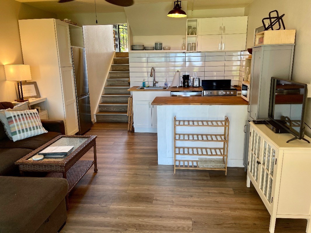 95-788 Ninole Loop Road, Unit 41 Naalehu, HI 96772 - Photo 6 of 19 a view of a kitchen with fridge and wooden floor