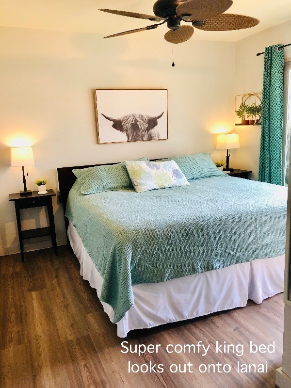 95-788 Ninole Loop Road, Unit 41 Naalehu, HI 96772 - Photo 8 of 19 a bedroom with a bed and wooden floor