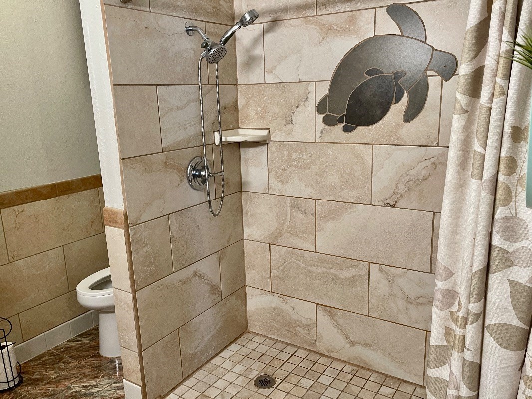 95-788 Ninole Loop Road, Unit 41 Naalehu, HI 96772 - Photo 10 of 19 a bathroom with a sink and a shower