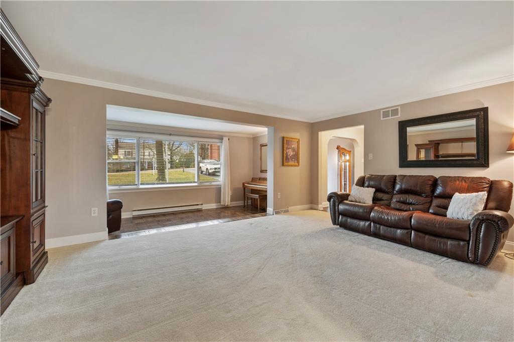 1787 Hassam Road Coraopolis, PA 15108 - Photo 12 of 28 The living room extends into a sunken sitting room. Large windows in the sitting room offer plenty of natural light.