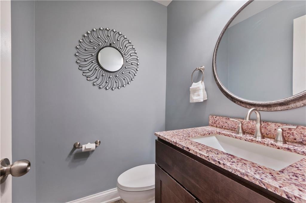 1787 Hassam Road Coraopolis, PA 15108 - Photo 14 of 28 The half bath includes a vanity with granite top and hardwood flooring.