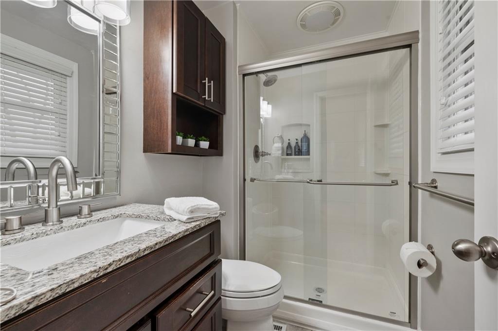 1787 Hassam Road Coraopolis, PA 15108 - Photo 17 of 28 The primary bathroom offers a walk-in shower, a vanity with granite top and tile floors.