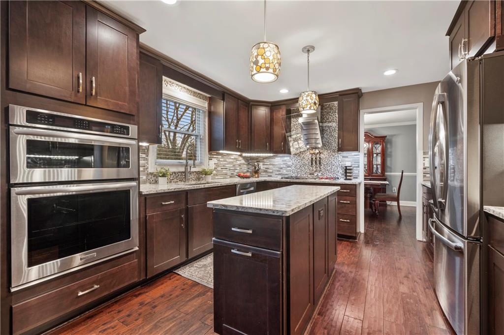 1787 Hassam Road Coraopolis, PA 15108 - Photo 4 of 28 The beautiful kitchen offers mocha cabinetry and granite countertops.